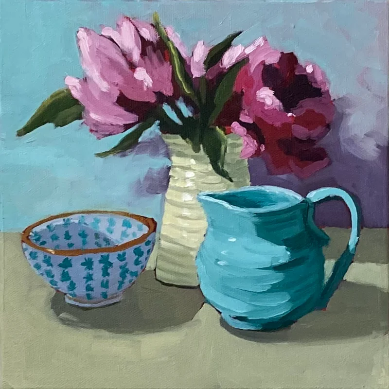 Oil painting of pink peonies in a vase with a blue bowl and creamer.